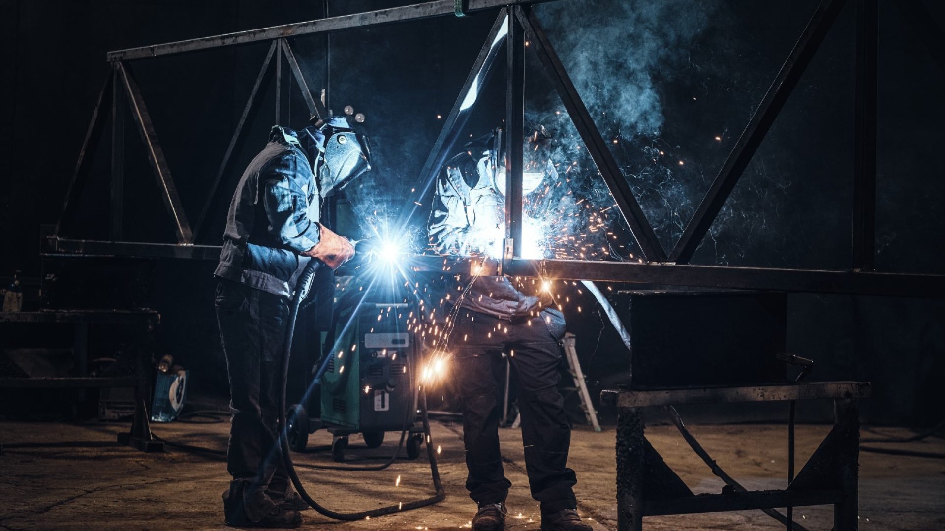 Welding work with metal construction at busy metal factory